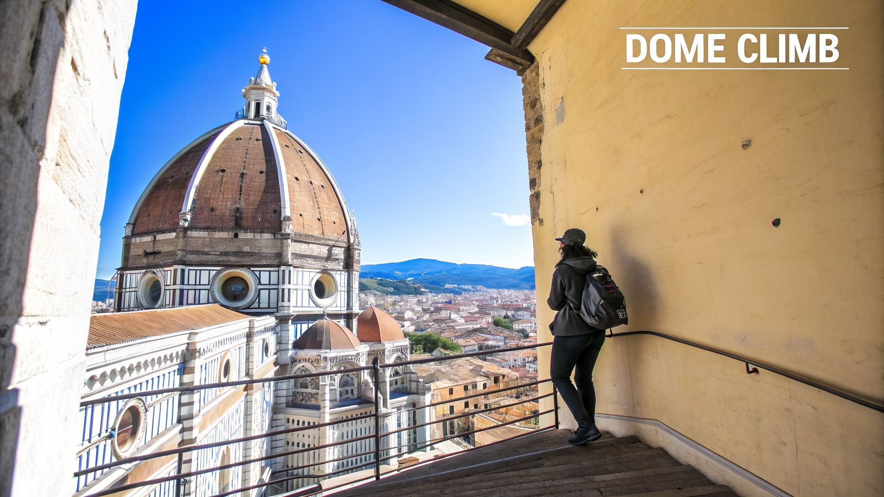 View from Florence Duomo climb, showing the iconic dome and cityscape with a person.