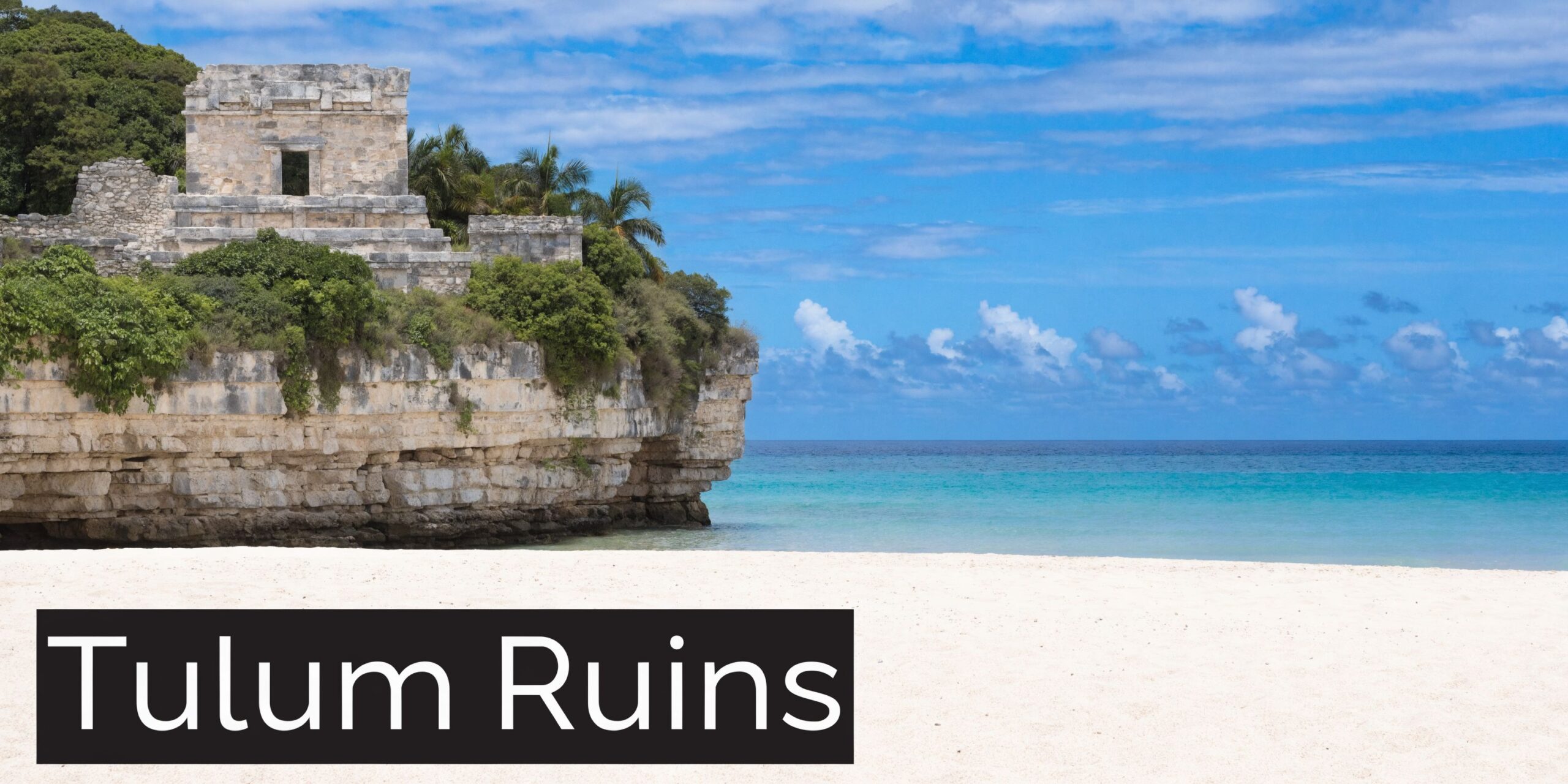 The ancient Mayan Tulum Ruins located on a rocky cliff overlooking the beautiful Caribbean Sea beach.