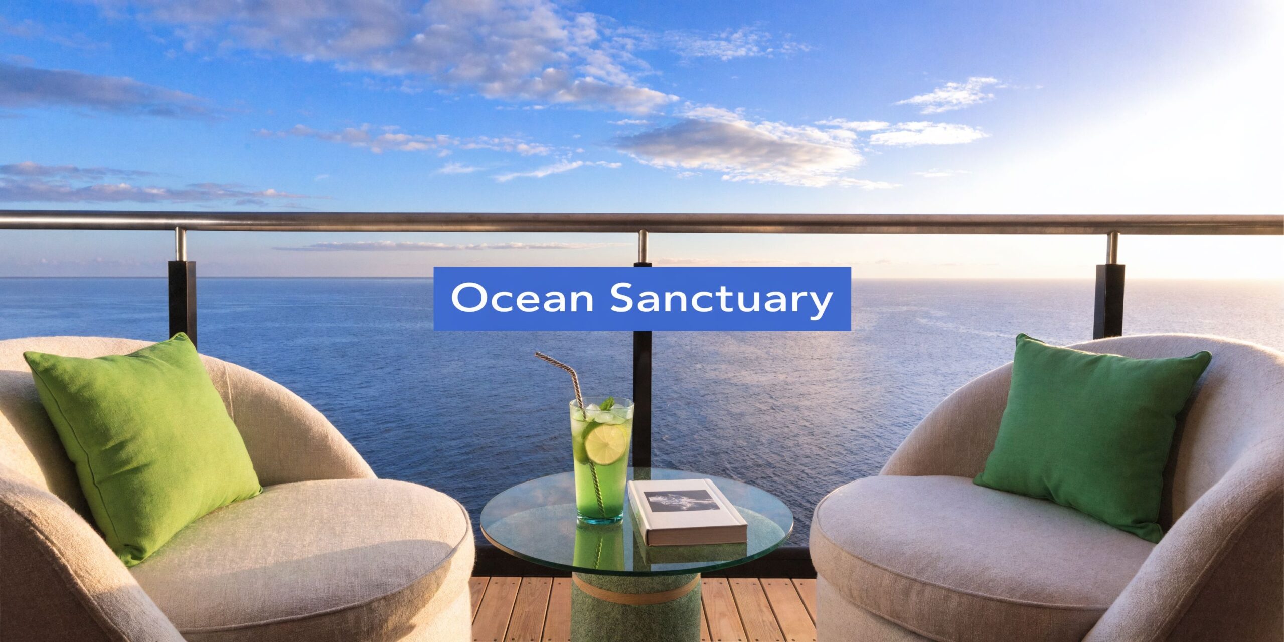 Two comfortable armchairs with green pillows face a serene ocean view from a cruise ship balcony.