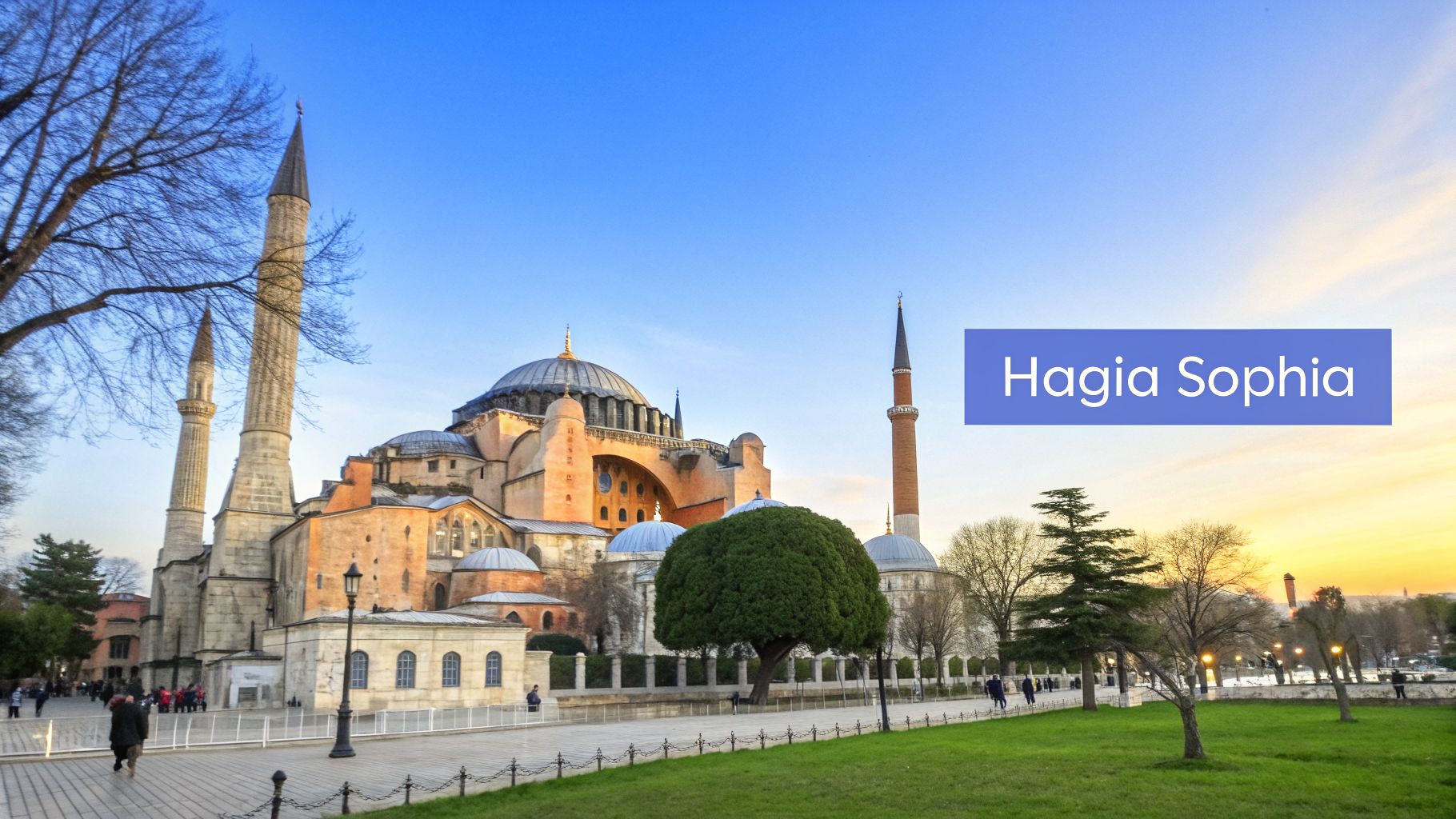 Hagia Sophia, a grand historic landmark in Istanbul, featuring a large dome and tall minarets under a blue sky.