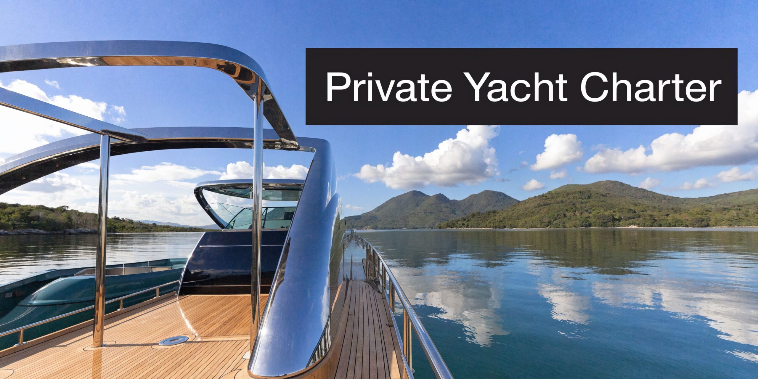 A luxurious yacht deck overlooking calm blue waters and distant green mountain islands under a sunny sky.