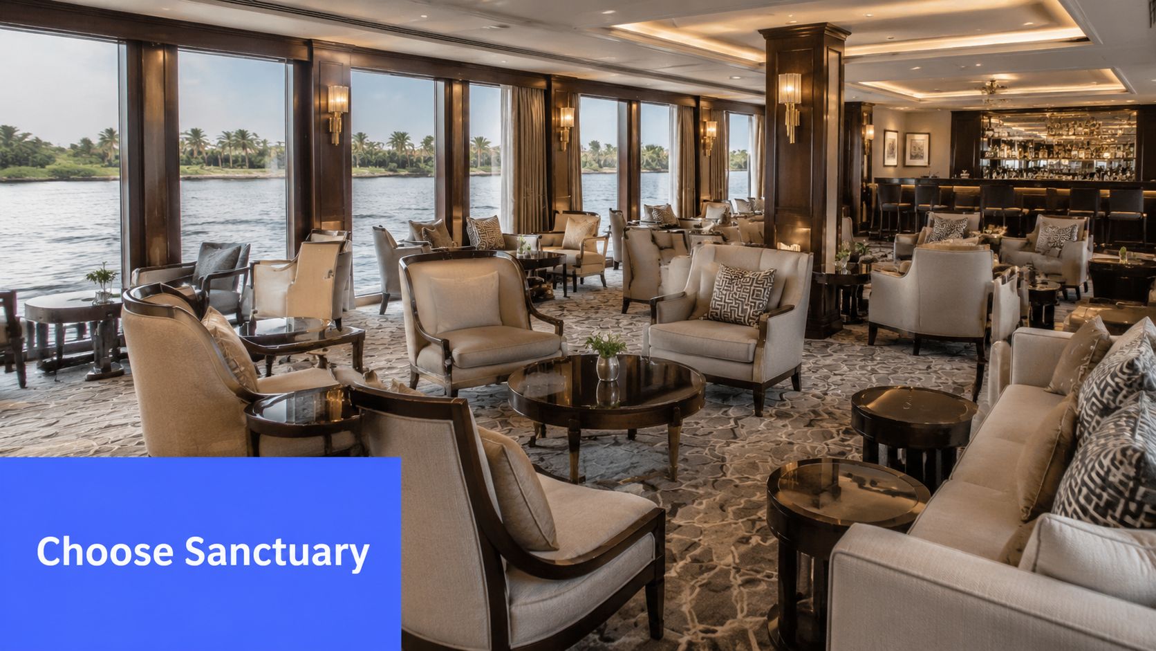 Luxurious lounge interior of a Nile River cruise boat with elegant seating and large windows overlooking water.