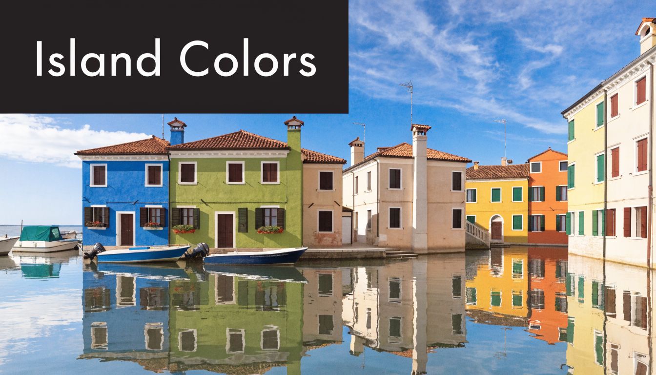 A scenic view of vibrant colorful houses along a canal in Burano, Venice, reflecting in the water.