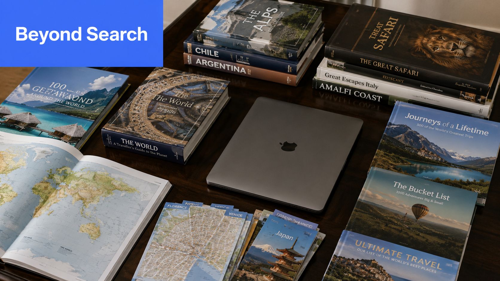 A collection of travel guidebooks, maps, and a laptop arranged on a wooden table for trip planning.