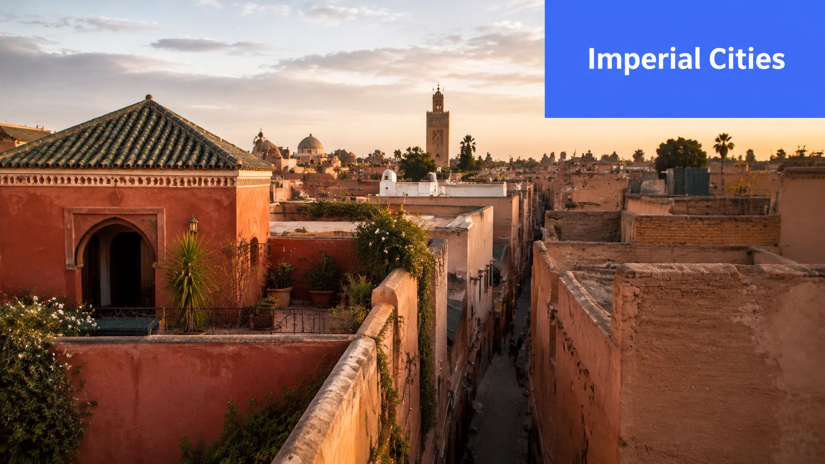 A scenic view of the red city of Marrakesh in Morocco with its iconic mosque tower at sunset.