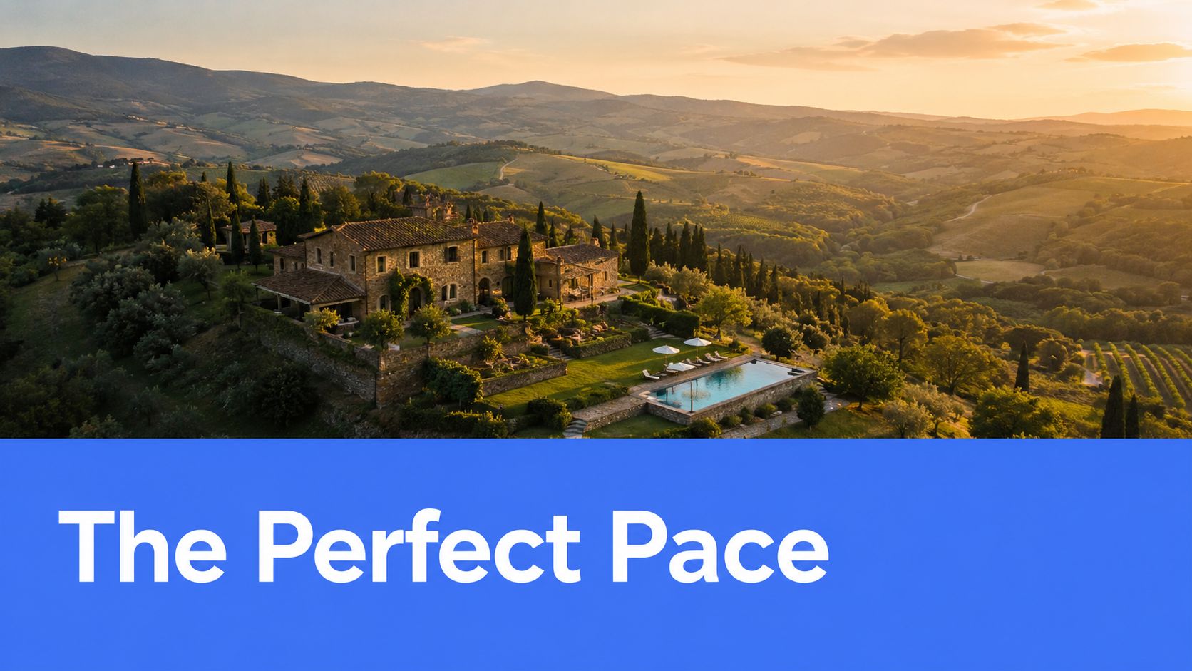 An aerial view of a stone villa estate in the Italian countryside at sunset with a pool.